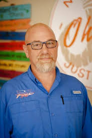 Mark Setterington, Co-Founder & CEO of Island Fin Poké Co., holding a signature poké bowl